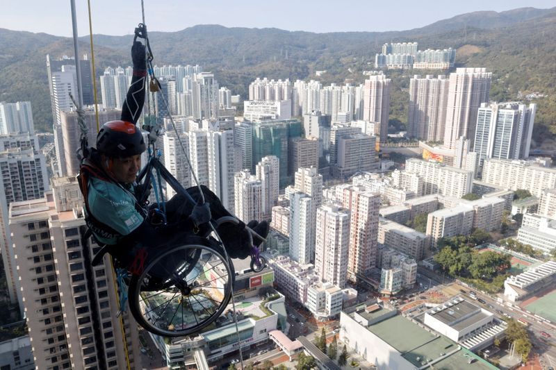 In wheelchair, paraplegic Lai Chi-wai climbs up skyscraper in Hong Kong