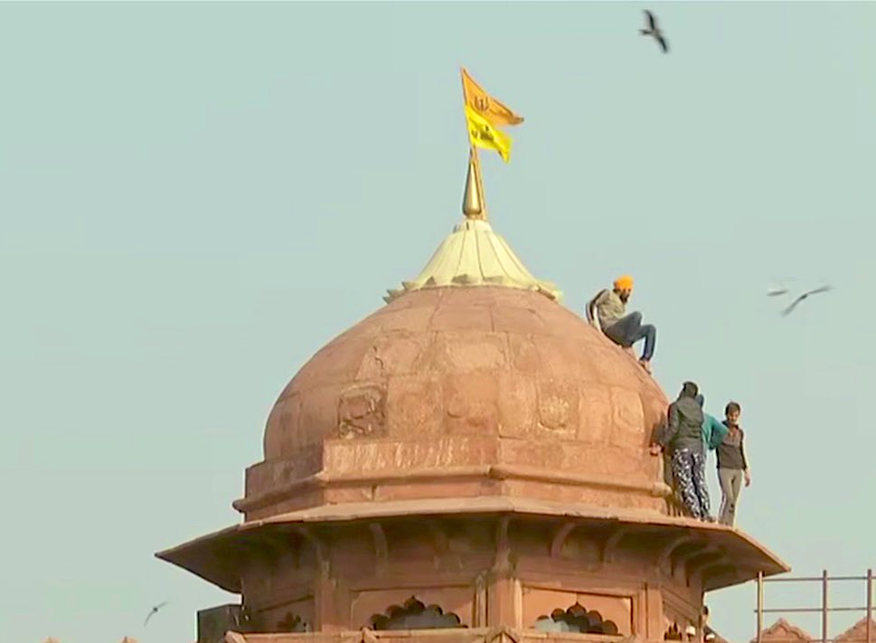 Indian farm protesters battle police to plant flags at historic Red Fort