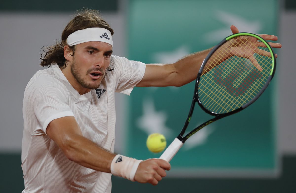 Steely Tsitsipas keeps cool to beat Isner in four sets