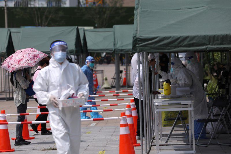 China reports more Covid-19 cases while some cities kick off new tests