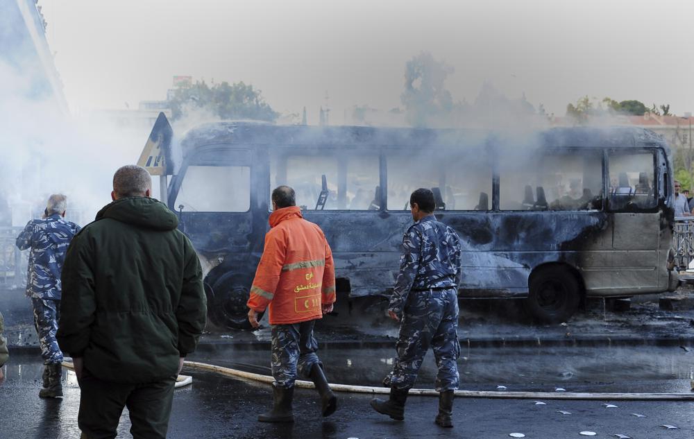 Bus bombs kill 14 in Syria capital, shells elsewhere kill 10