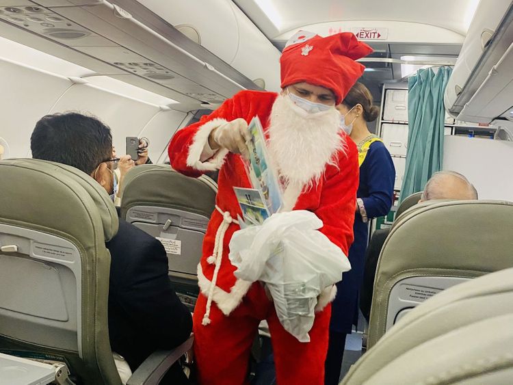 Santa Claus appears on PIA flight to distribute Christmas gifts