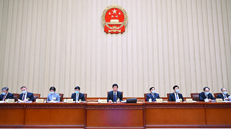 China's top legislature reviews work report, draft agenda for upcoming annual session