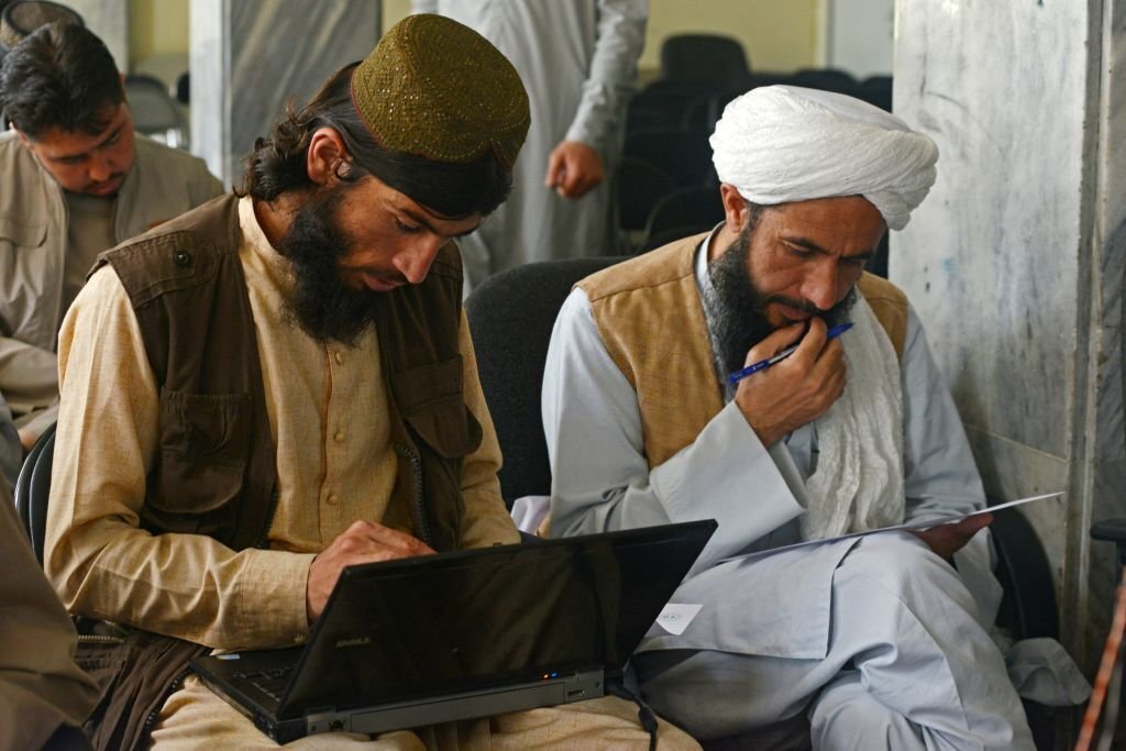 Taliban fighters swap arms for books as hundreds return to school