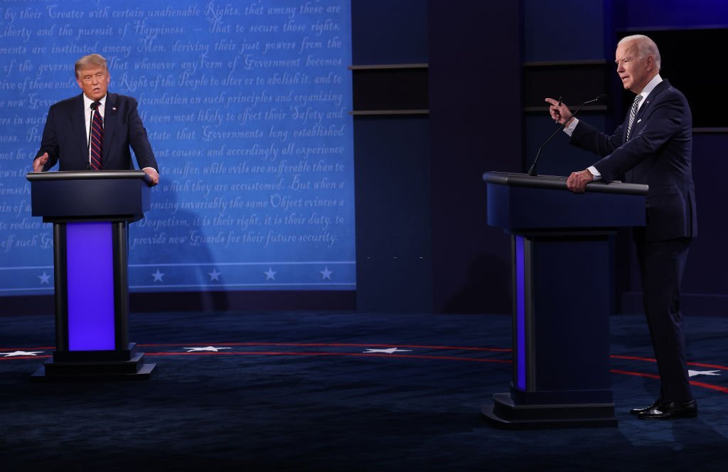 Biden warns on risk to democracy, Trump hints at another run on eve of midterms