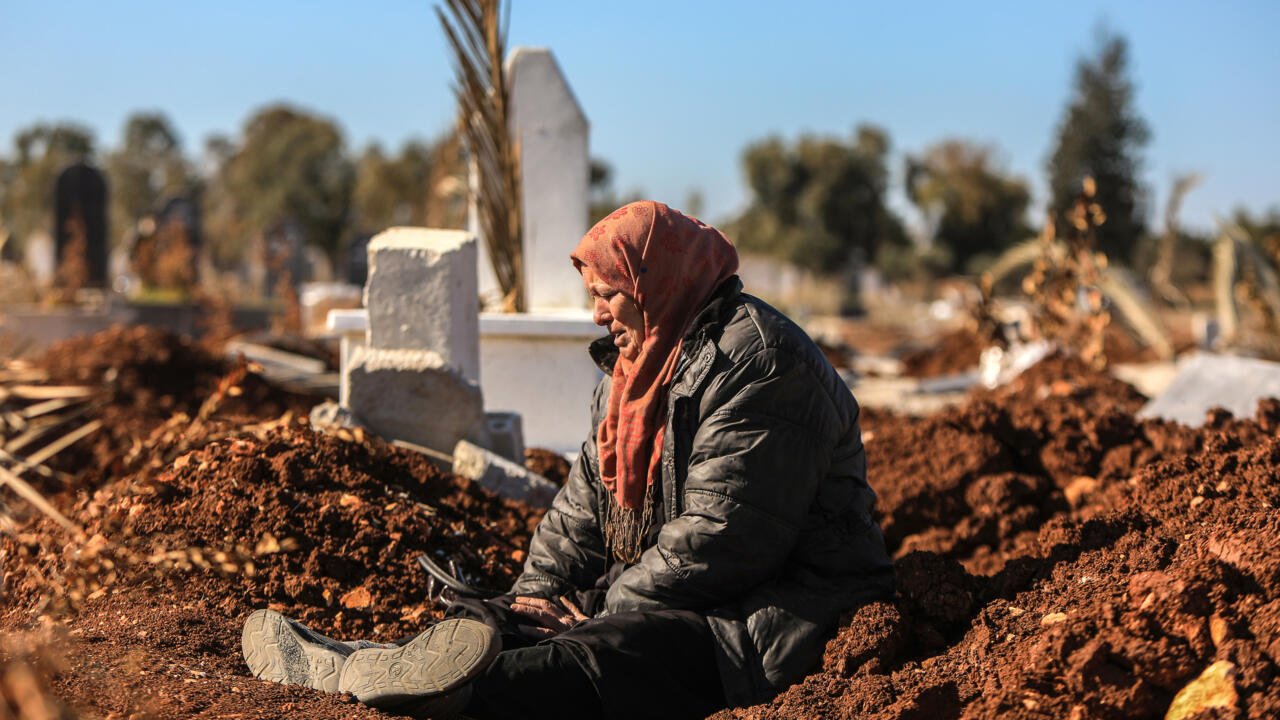 At Syria cemetery, people search for missing loved ones